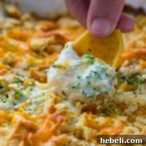 Delicious Broccoli Cheese Dip in a square baking dish, ready to be served hot and bubbly.