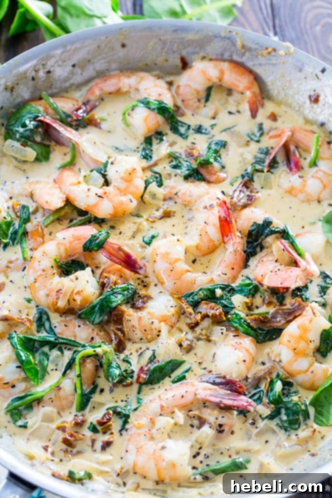 Shrimp in Tuscan Cream Sauce 3 Close-up of Creamy Tuscan Shrimp with sun-dried tomatoes and spinach, ready to be served.