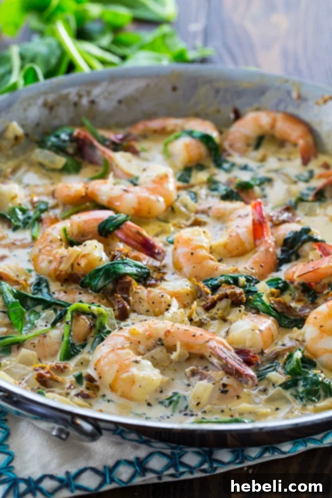 Shrimp in Tuscan Cream Sauce 4 Creamy Tuscan Shrimp simmering in a luxurious Parmesan sauce, showcasing its vibrant ingredients.