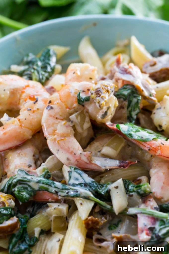 Shrimp in Tuscan Cream Sauce 5 Creamy Tuscan Shrimp perfectly plated over a bed of pasta, garnished and ready to enjoy.