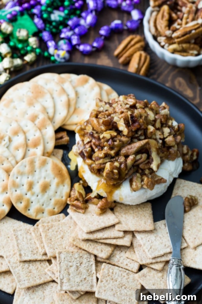 New Orleans Pecan Cream Cheese 3 French Quarter Pecan Cheese Spread with praline sauce dripping down the sides, ready to be served.