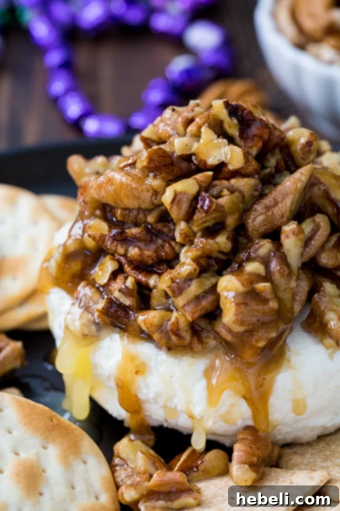 New Orleans Pecan Cream Cheese 4 A serving of French Quarter Pecan Cheese Spread on a plate, garnished with fresh herbs, ready for a party.