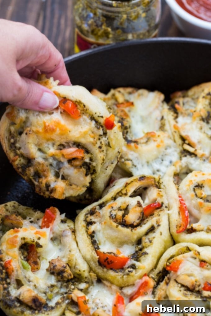 Chicken Pesto Pizza Rolls made with refrigerated pizza dough, served with a side of marinara sauce.