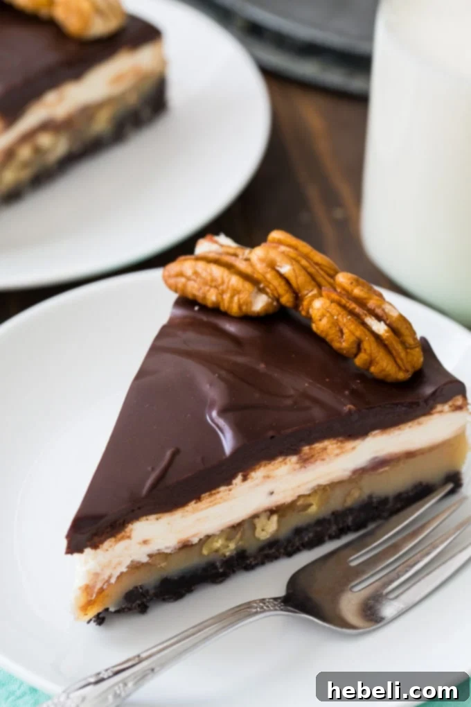 Praline Cream Cheese Dream Pie 3 A close-up of a slice of Praline Cream Cheese Pie, showing the distinct chocolate ganache, cream cheese, and pecan praline layers.