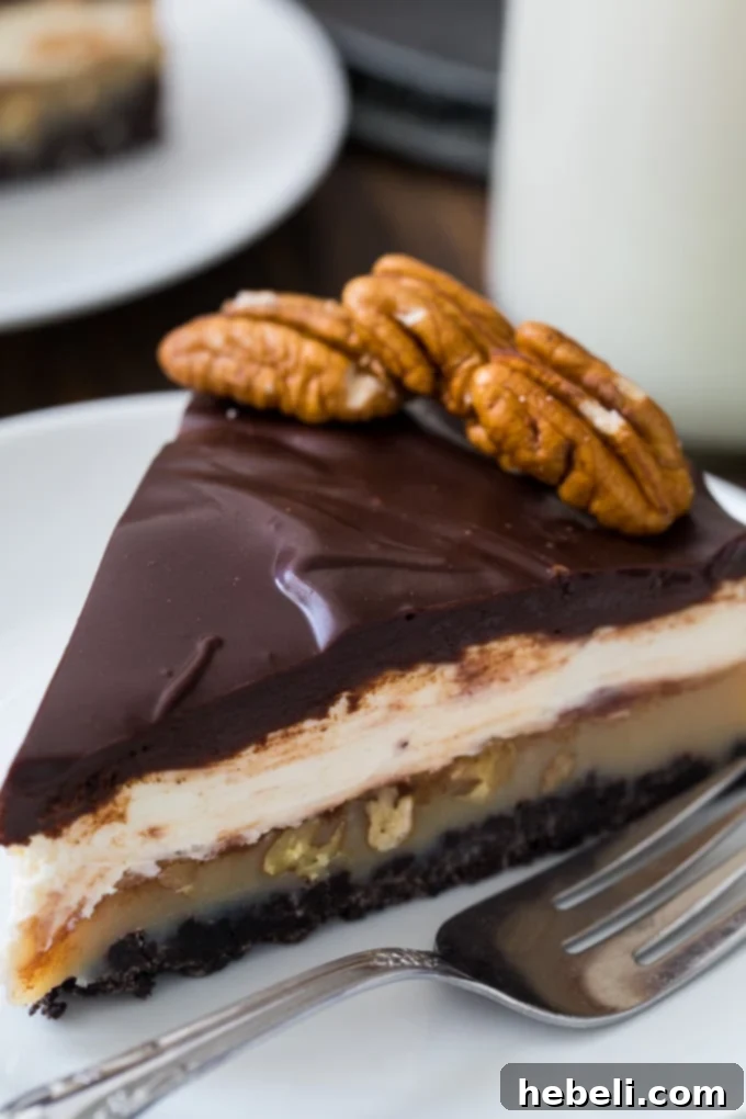 Praline Cream Cheese Dream Pie 4 A whole Praline Cream Cheese Pie, garnished with whole pecans, showcasing its exquisite layers and inviting appearance.