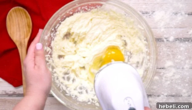 Mixing in eggs into cake batter.