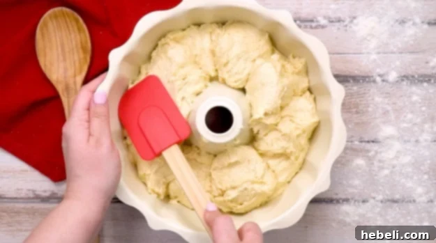 Cake batter poured into a Bundt pan, ready for baking.