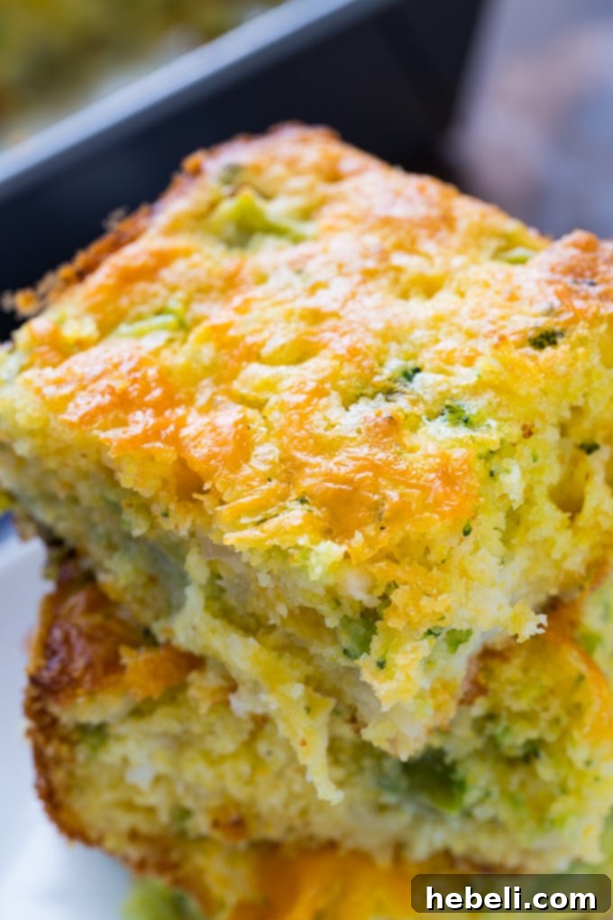 Golden Cheesy Broccoli Cornbread 5 Cheesy Broccoli Cornbread cut into squares and arranged on a wooden serving board.