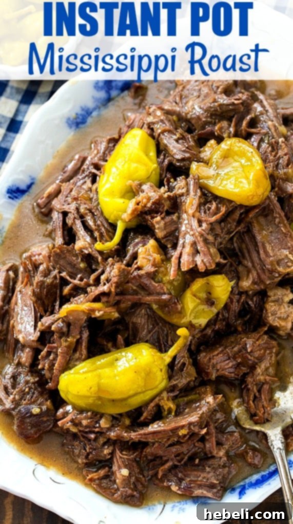 Mississippi Pot Roast: Instant Pot Edition 8 Shredded Roast on a serving platter with pepperoncini peppers and fresh herbs.
