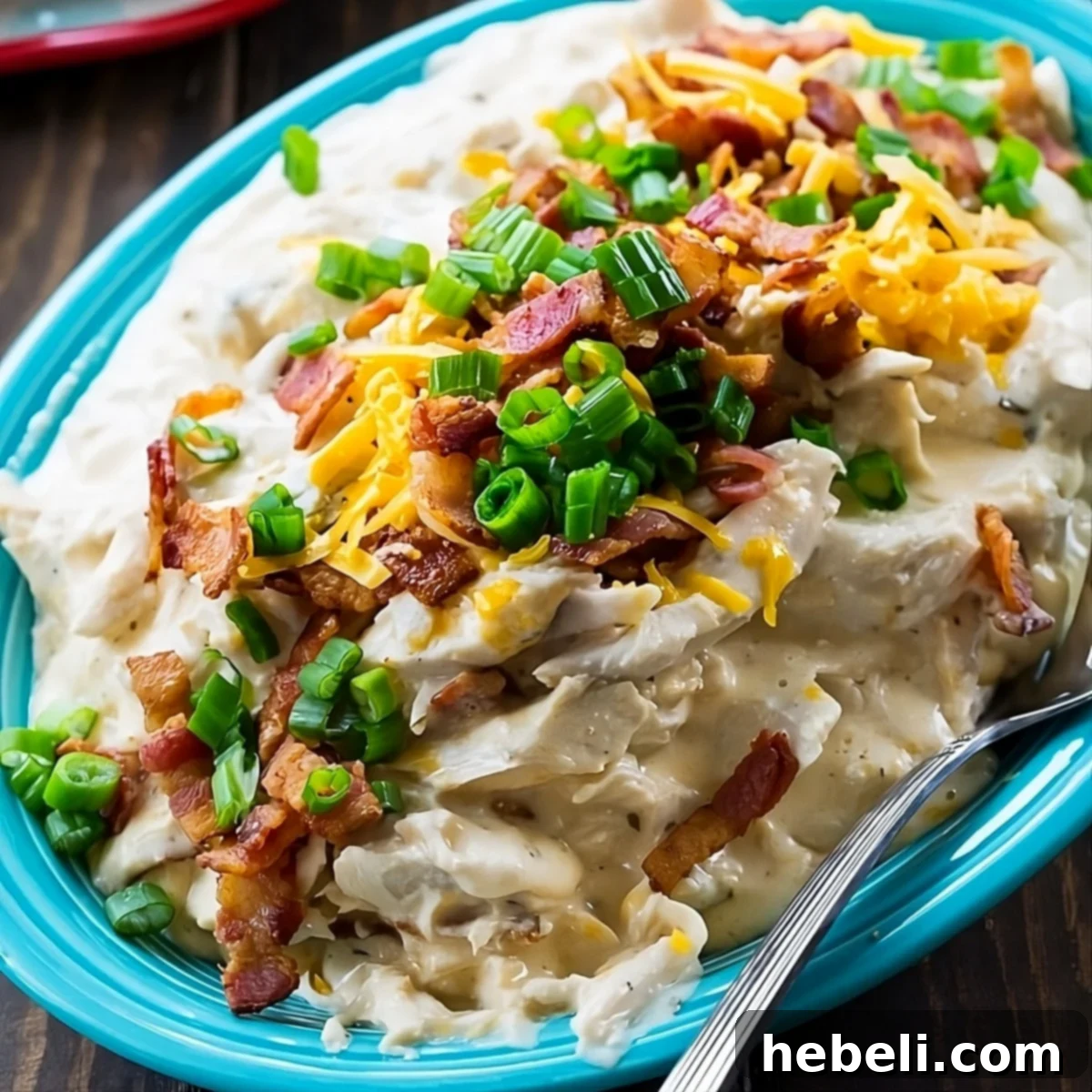 Addictive Instant Pot Chicken 2 A serving platter brimming with creamy Instant Pot Crack Chicken, garnished with bacon and green onions, ready to be enjoyed.
