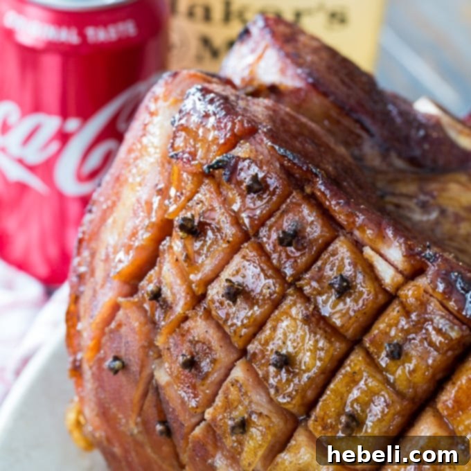 Delicious Bourbon and Coke Glazed Ham, beautifully carved and ready to serve, perfect for Easter dinner