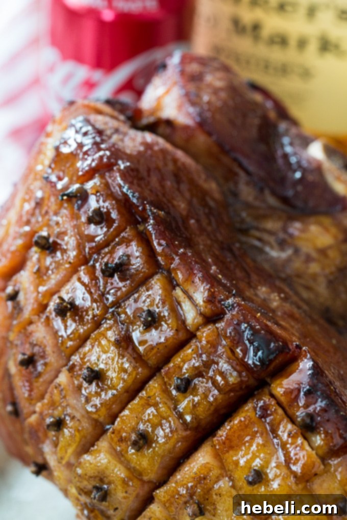 Bourbon and Coke Glazed Ham scored and studded with cloves, ready for baking for a festive southern Easter celebration