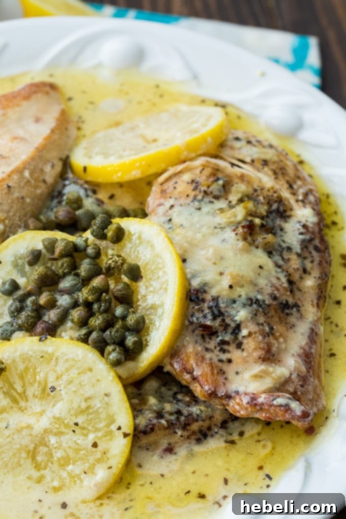Close-up of Crock Pot Lemon Chicken in a creamy sauce, ready to serve and enjoy.