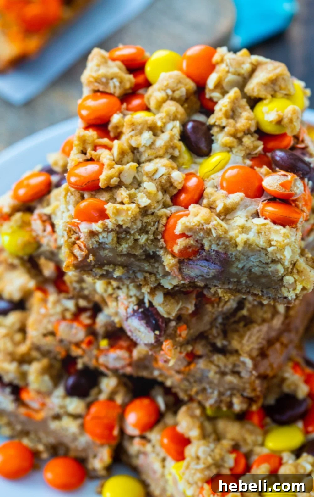 Close-up of a slice of Reese's Pieces Peanut Butter Oatmeal Bar, showing the layered texture.