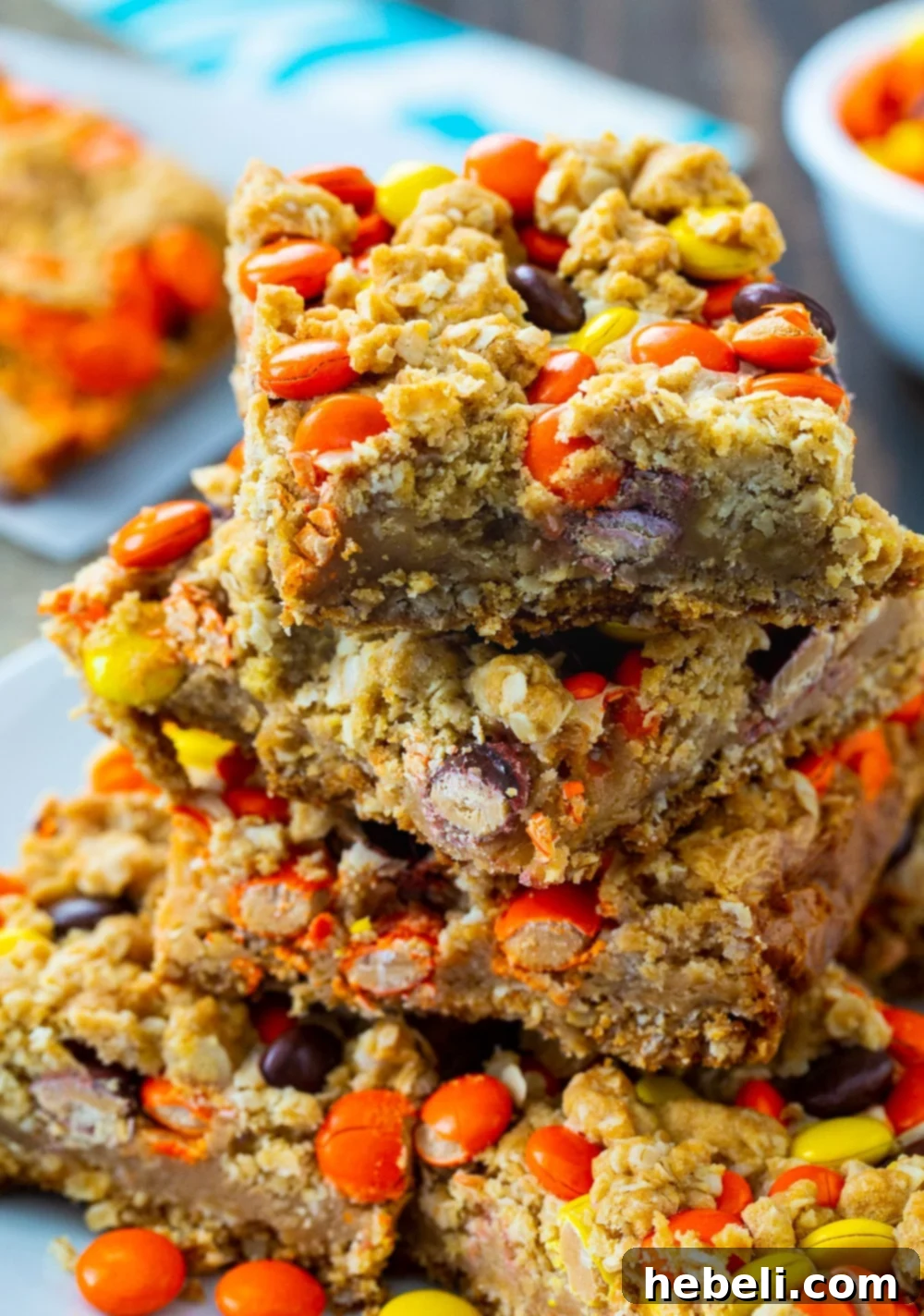 A stack of golden brown Reese's Pieces Peanut Butter Oatmeal Bars.