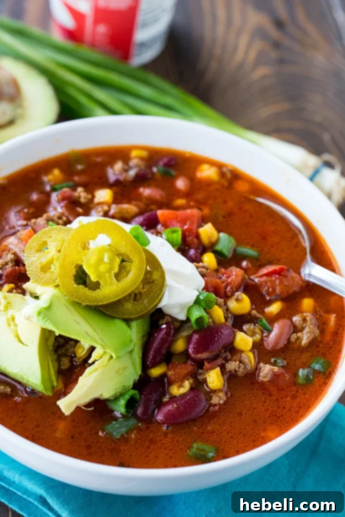 All the fresh and canned ingredients for Instant Pot Taco Soup laid out on a kitchen counter, including ground beef, diced tomatoes, kidney beans, corn, and various seasoning packets