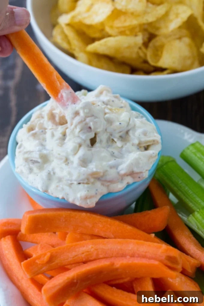 Caramelized Onion Dip 3 Creamy Pan-Fried Onion Dip with vibrant veggie sticks and crunchy chips, ready to be served.