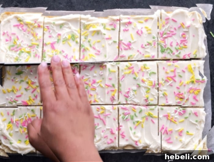 Cutting the frosted sugar cookie bars into individual servings