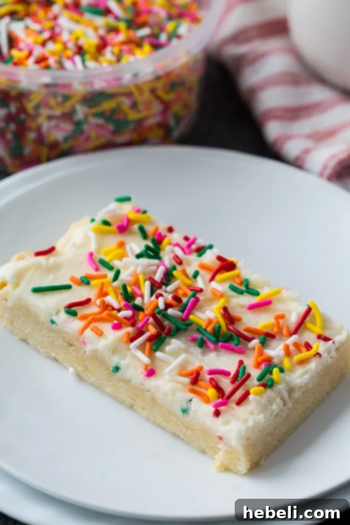Beautifully frosted Sugar Cookie Bars ready to be sliced and served