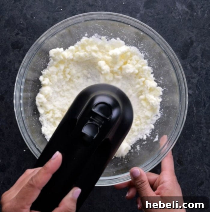 Creaming butter and sugar until light and fluffy for sugar cookie bars