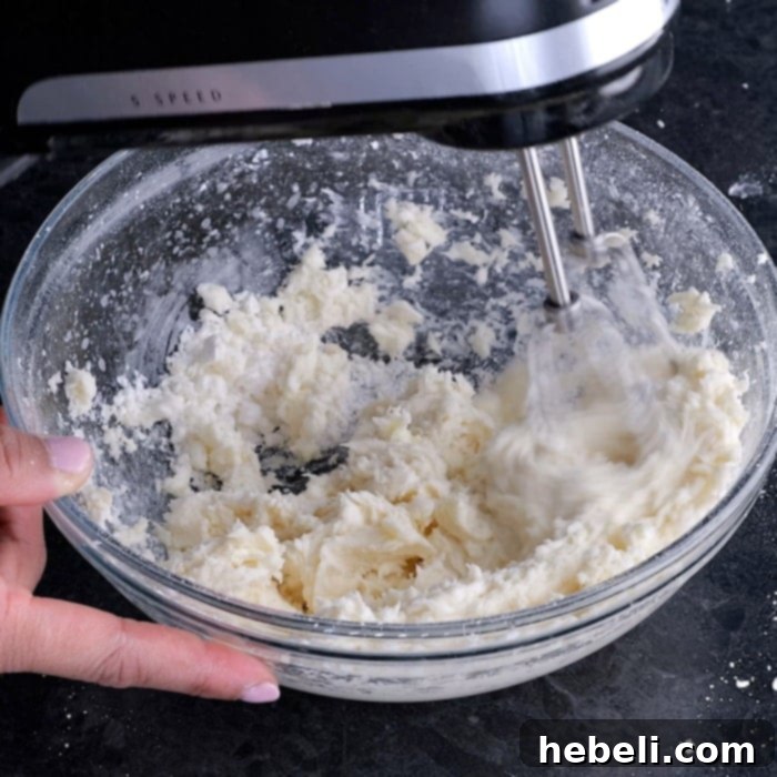 Mixing the buttercream frosting until smooth and creamy