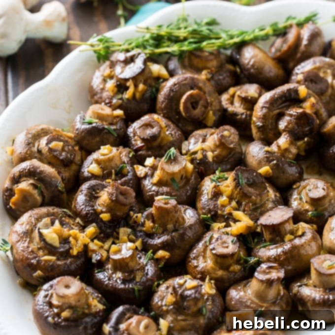 Golden Garlic Butter Roasted Mushrooms 2 Close-up of perfectly roasted mushrooms glistening with garlic butter sauce