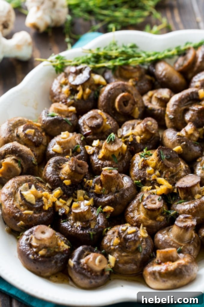 Golden Garlic Butter Roasted Mushrooms 3 Freshly roasted mushrooms coated in a rich garlic butter sauce, ready to serve.