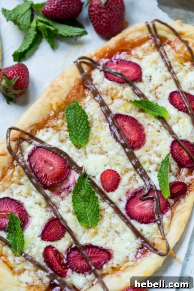 Close-up of Strawberry Nutella Dessert Pizza with mascarpone and fontina cheese before final bake