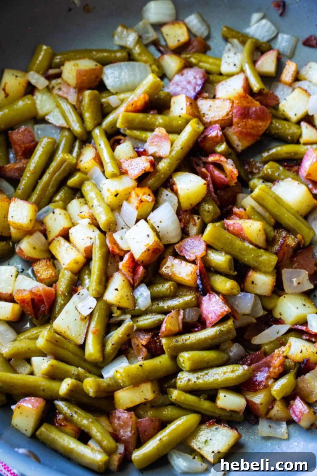 The finished Country Ranch Green Beans and Potatoes dish simmering in a skillet, showcasing its rustic appeal.