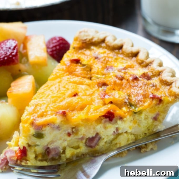 Delicious Denver Omelet Quiche with ham, bell peppers, and onions, sliced and ready to serve