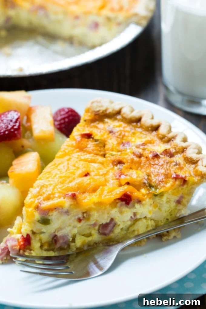 Close-up of Denver Omelet Quiche showcasing its creamy texture and filling of ham, peppers, and cheese