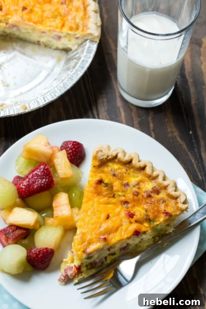 Denver Omelet Quiche baking in the oven, with its vibrant ham, onion, and bell pepper filling visible