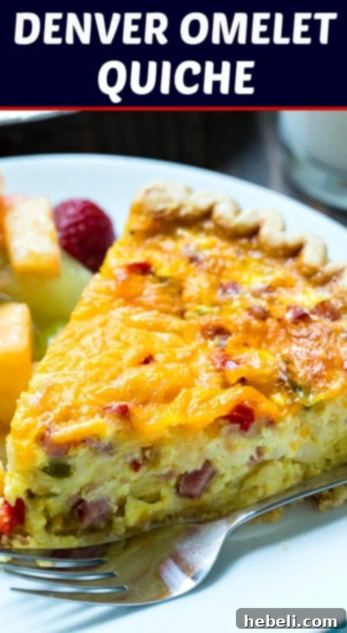 A slice of Denver Omelet Quiche on a plate, revealing layers of ham, onion, and bell pepper in a golden custard