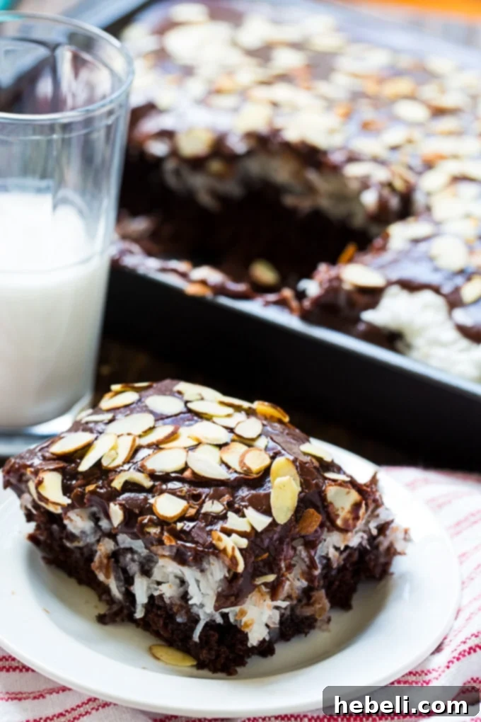 Coconut Almond Chocolate Dream Cake 4 Close-up of a slice of Almond Joy Cake, showing the gooey coconut and chocolate layers