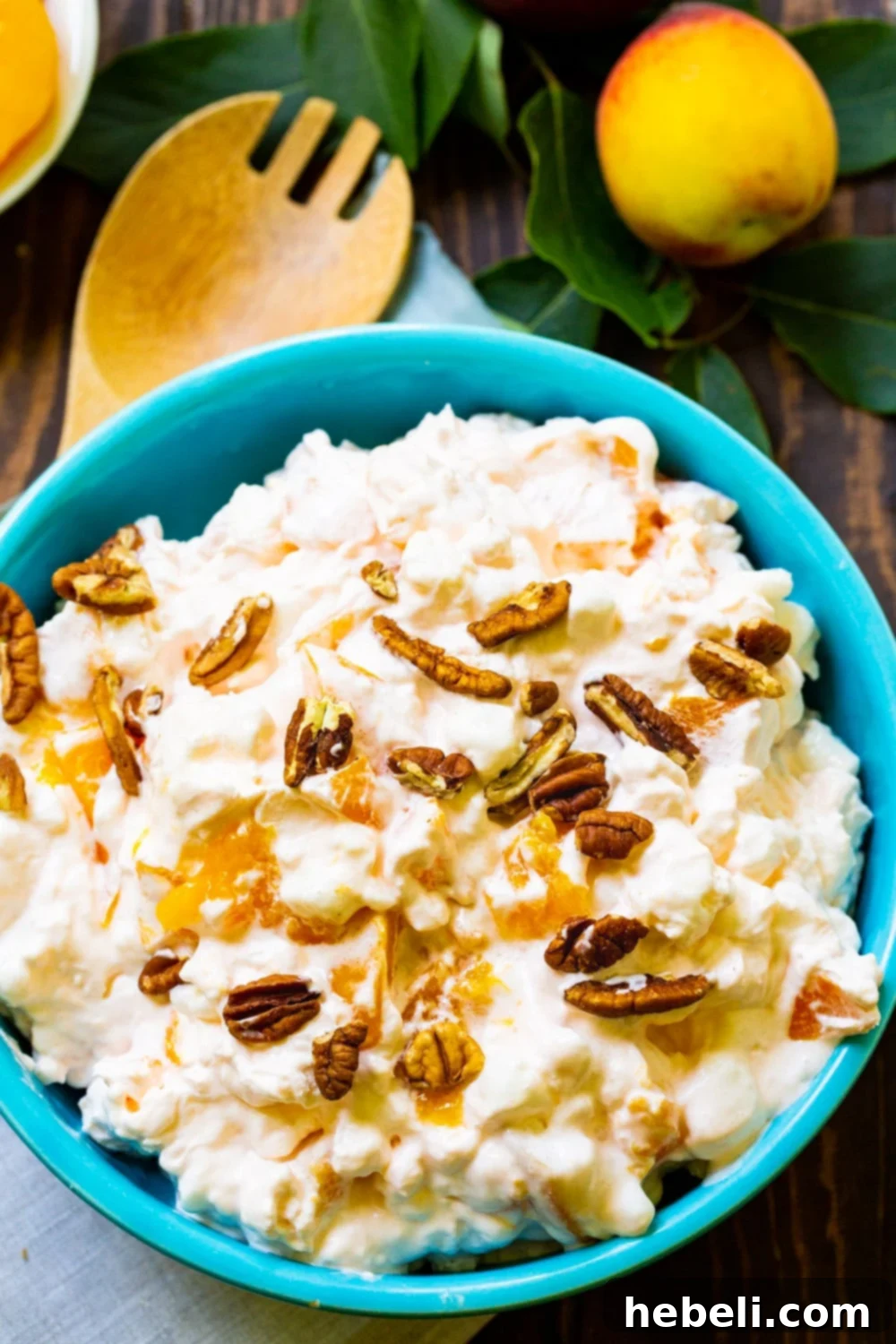 Golden Peach Ambrosia 3 An overhead shot of Millionaire Peach Salad in a bowl, showcasing its creamy texture and peach chunks, perfect for sharing.