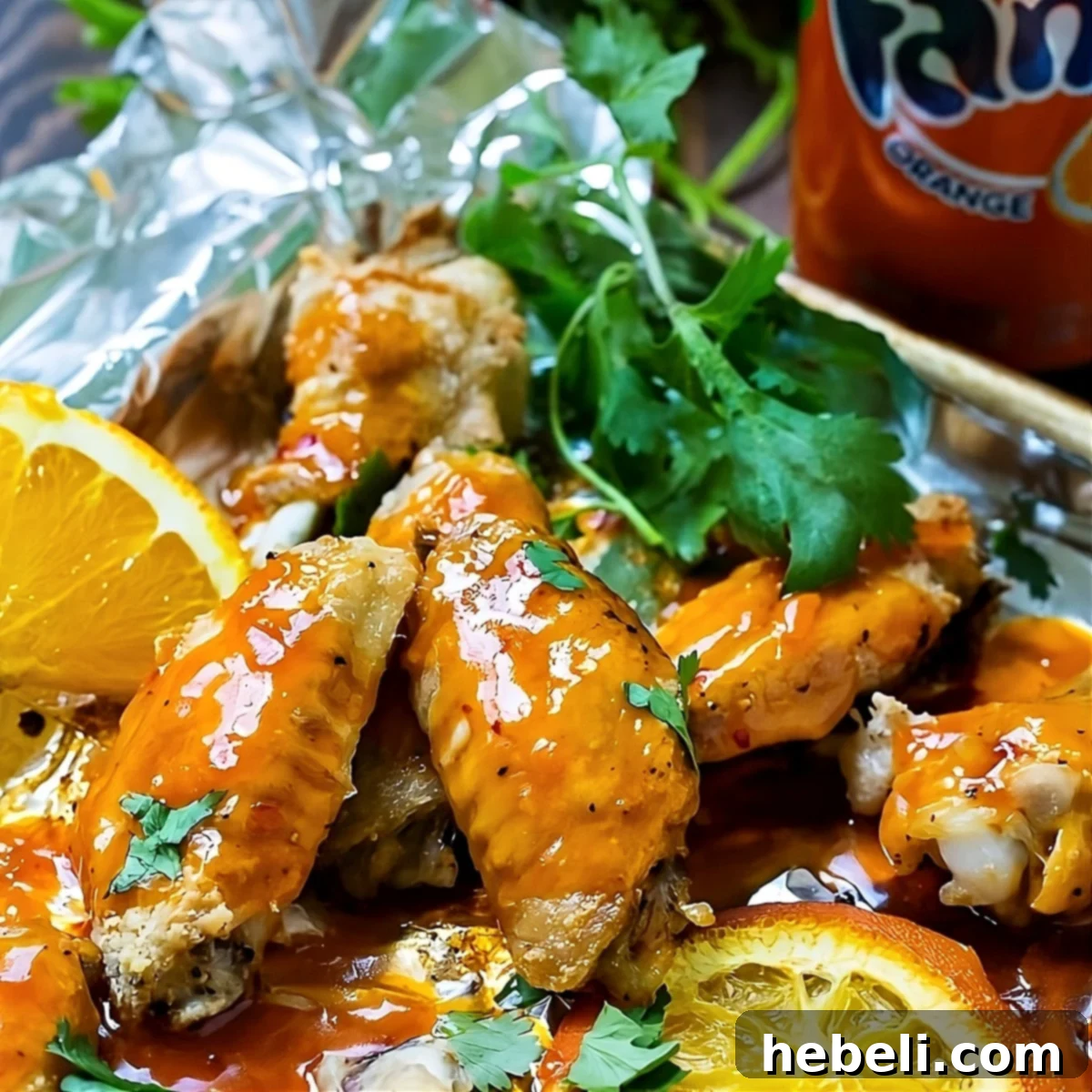 Zesty Orange Fire Wings 2 Crispy Orange Soda Hot Wings piled on a baking sheet, garnished with fresh cilantro.