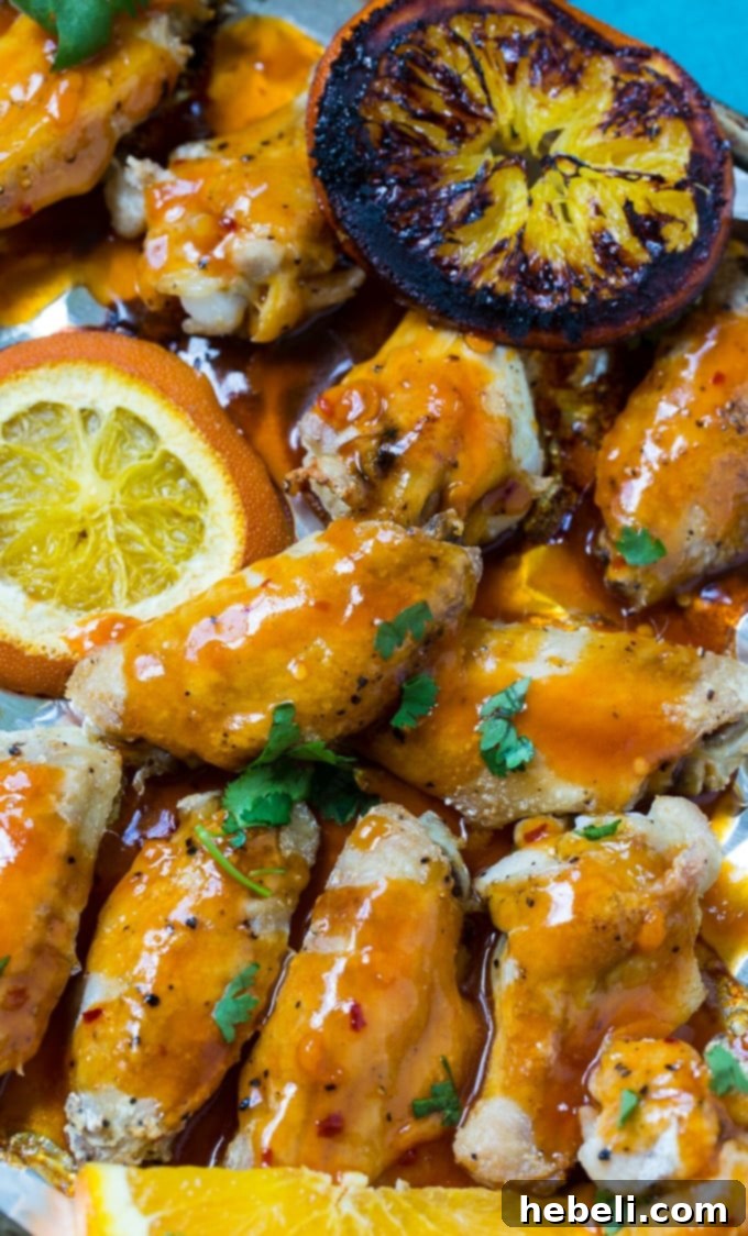 Zesty Orange Fire Wings 3 Delicious Baked Orange Soda Hot Wings on a plate, garnished and ready to serve.