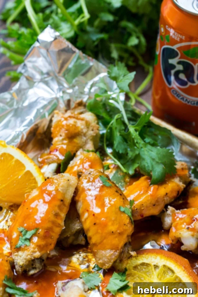 Zesty Orange Fire Wings 4 Close-up of baked Orange Soda Hot Wings, showcasing their crispy texture and glossy sauce.