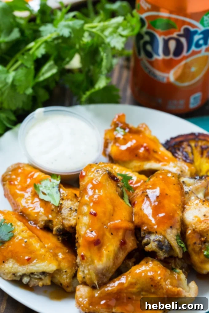 Zesty Orange Fire Wings 5 The best Orange Soda Hot Wings, glistening with sauce and ready for serving.