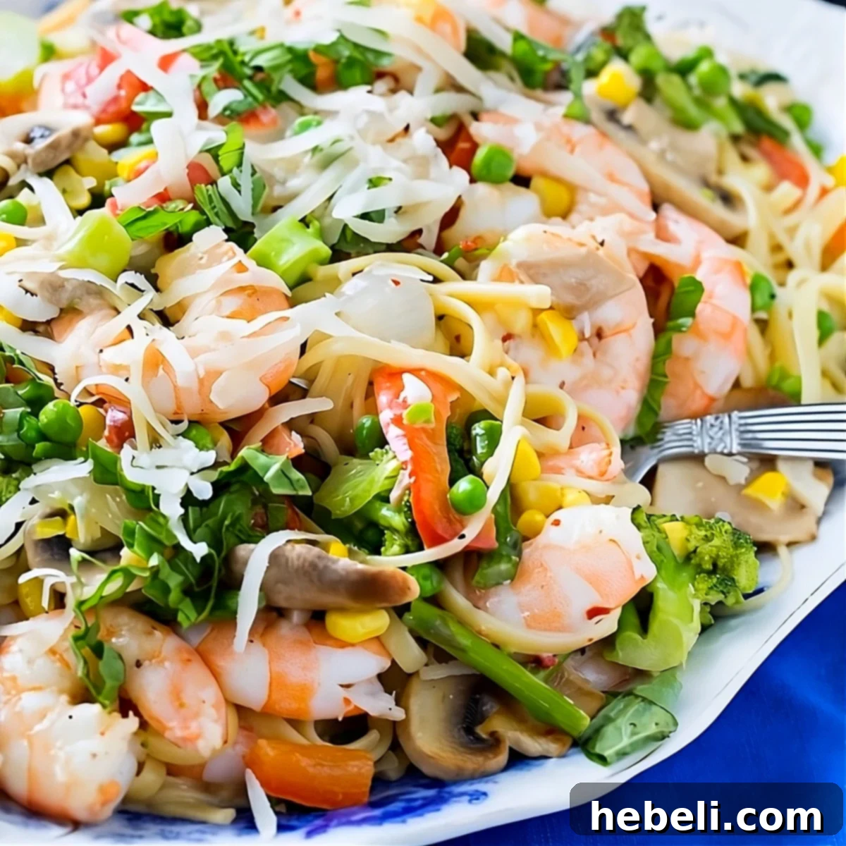 Spring's Bounty Shrimp Pasta 2 Shrimp Pasta Primavera on a serving platter, showcasing fresh ingredients and creamy sauce.
