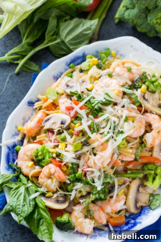Spring's Bounty Shrimp Pasta 3 Shrimp Pasta Primavera with lots of fresh vegetables in a creamy sauce, ready to be served.