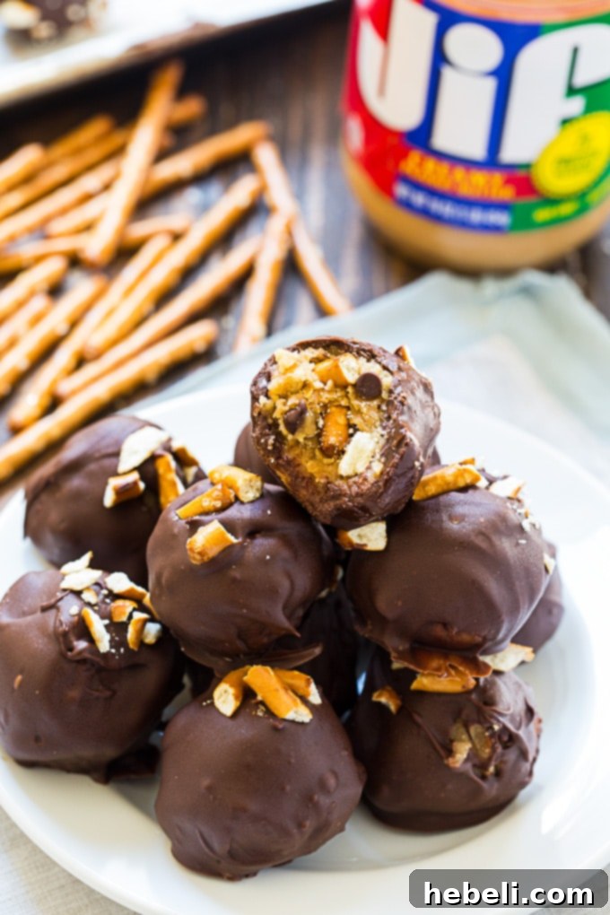 Chocolate-covered Peanut Butter Pretzel Truffles artfully arranged on a serving platter, highlighting their glossy finish.