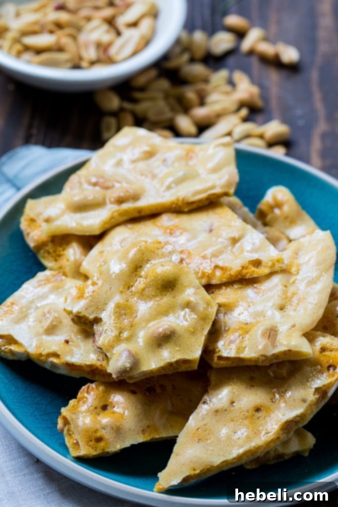 Easy Homemade Microwave Peanut Brittle being poured onto parchment paper