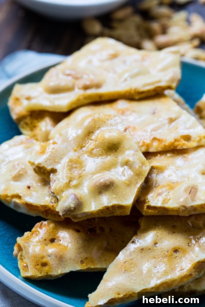 Close-up of golden Easy Microwave Peanut Brittle pieces
