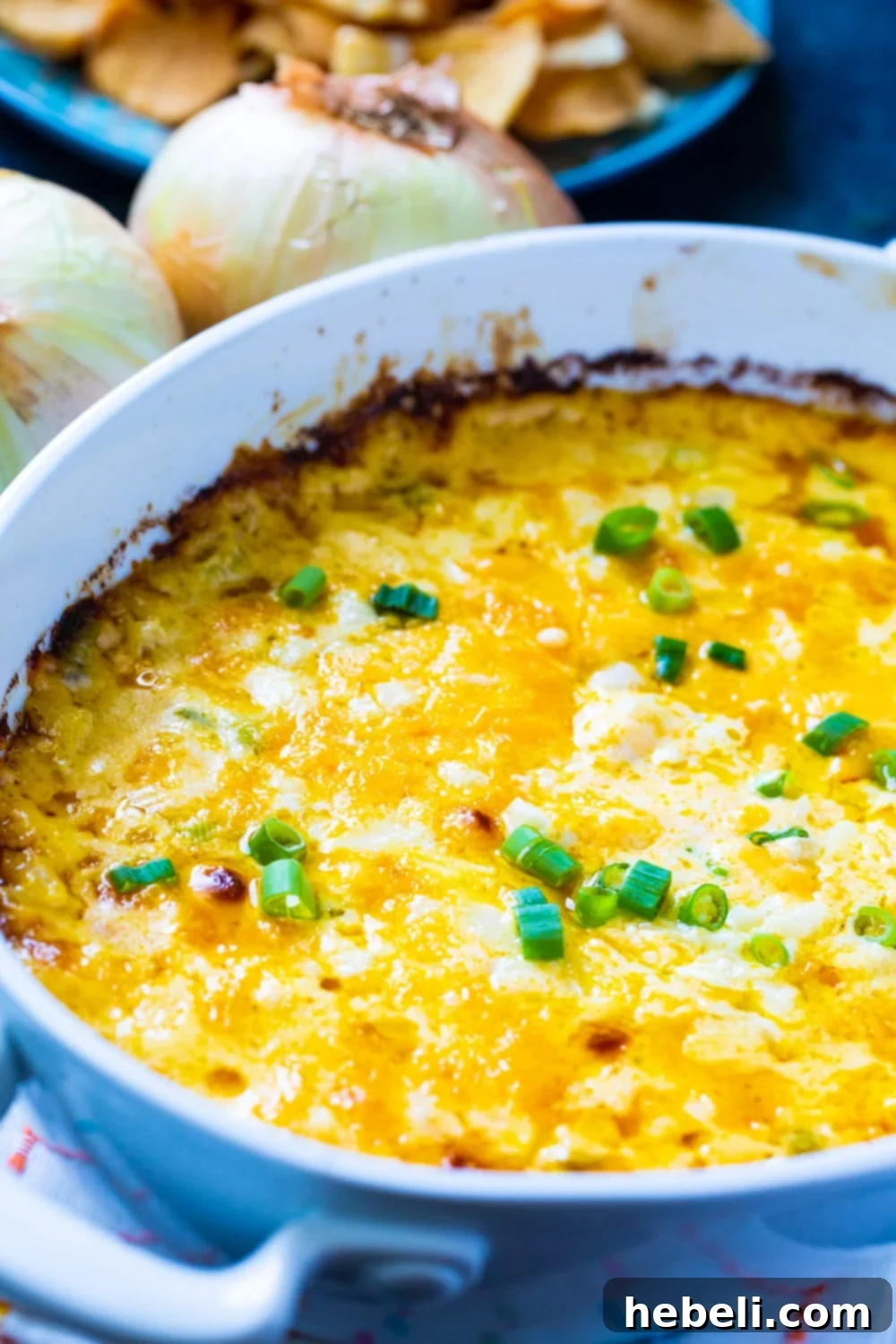 Irresistible Vidalia Onion Dip 3 Hot Vidalia Onion Dip baking in a dish, showing its cheesy texture.