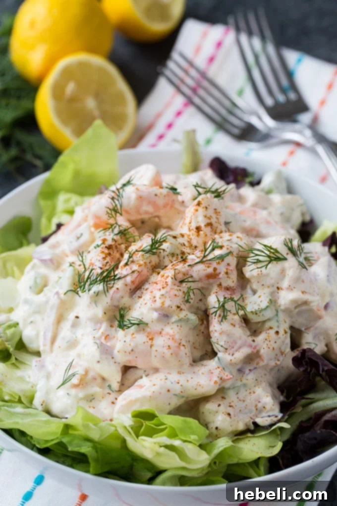 A bowl of creamy Southern Shrimp Salad with a spoon, ready to be served