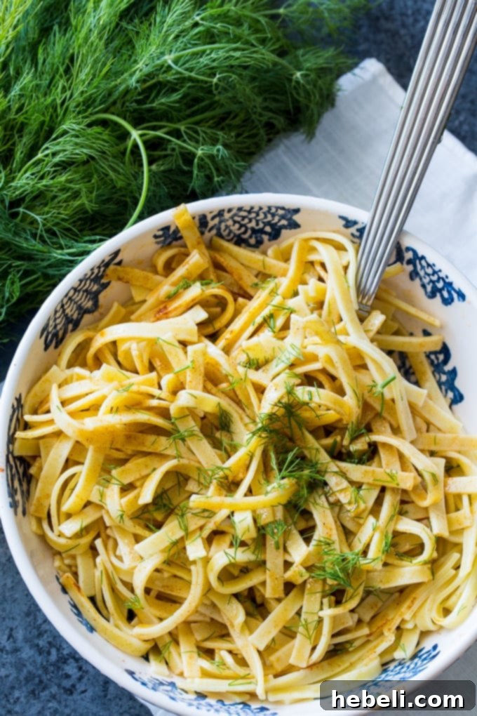 Close-up of dry Kluski noodles on a cutting board