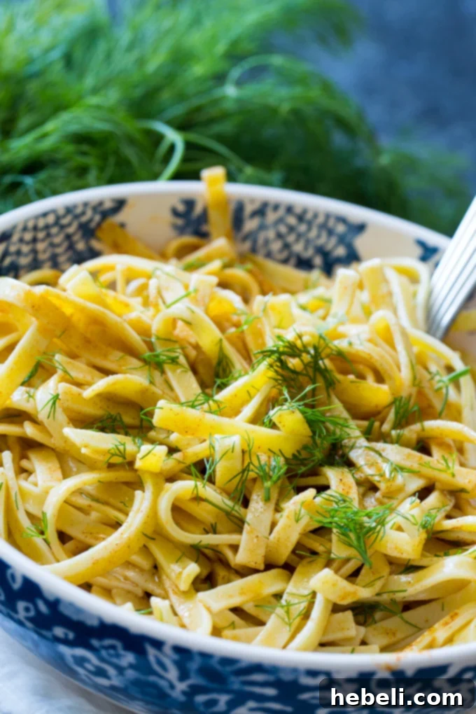 A bowl of Dilled Egg Noodles garnished with fresh dill