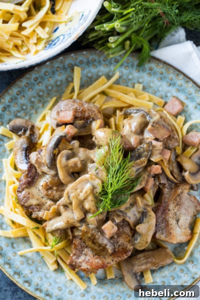 Close-up of German Pork Cutlets with creamy mushroom sauce, showcasing the tender pork.