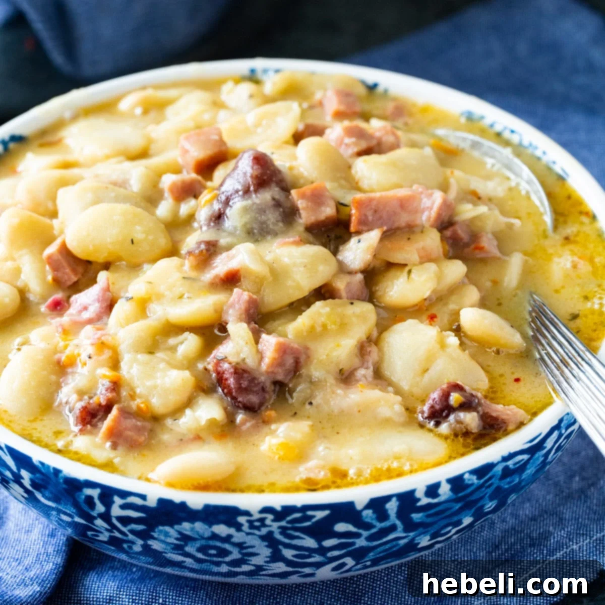 A bowl of creamy butter beans, garnished with fresh herbs, showcasing their thick texture and rich color. A perfect representation of Southern comfort food.